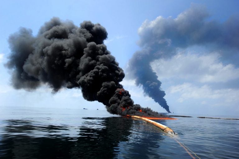 Dark clouds of smoke and fire emerge as oil burns in the Gulf of Mexico following the April 20 explosion on the Deepwater Horizon. U.S. Navy photo by Specialist 2nd Class Justin Stumberg