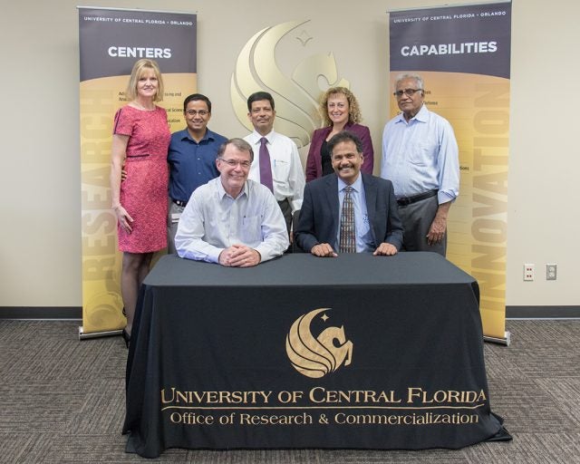 Celebrating the licensing agreement: (seated L to R), Thomas O’Neal, UCF and Sundar Muruganandhan, Versa Drives, along with members of UCF's Office of Technology Transfer (standing L to R) Andrea Adkins, Narasimha Nagaiah (Raju), Durgasharan Krishnamurthy, Versa Drives, Svetlana Shtrom, and Shan Venkatachalam, Versa Drives.