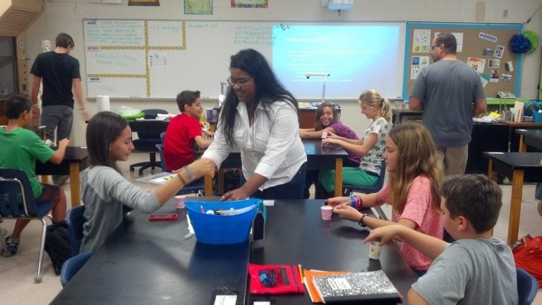 UCF student Dahlia Hurtado provides a lesson to science students at Jackson Heights Middle School in Oviedo as part of the service learning component of UCF's new nanoscience minor.
