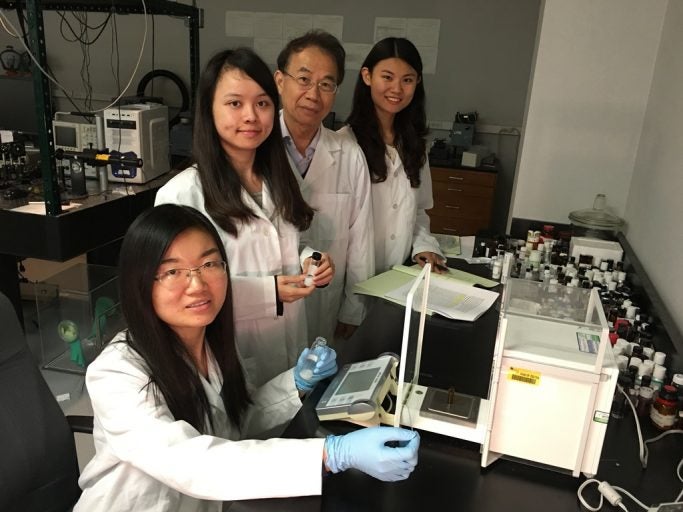 Dr. Shin-Tson Wu and doctoral students work on new liquid crystal mixtures in his lab at the College of Optics & Photonics. From left, Fenglin Peng, Fangwang "Grace" Gou, Wu and Yuge "Esther" Huang.