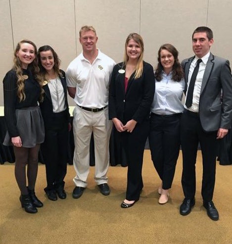 L-R: Micaela Cleere, Amelia Gallo, Coach Scott Frost, Jordyn Decker, Eliana Benevento, and Kiefer Schoenfeld.