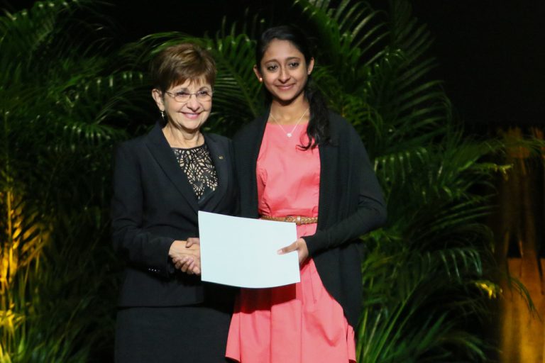 Deborah German, dean of the College of Medicine, presents a student award to Getasha Doobay. (Photo by Nick Russett)