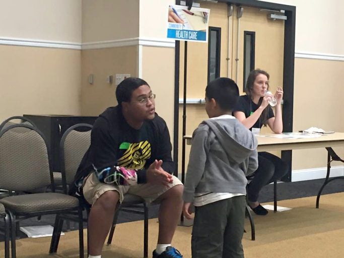 Volunteer interacts with participant during the simulation.