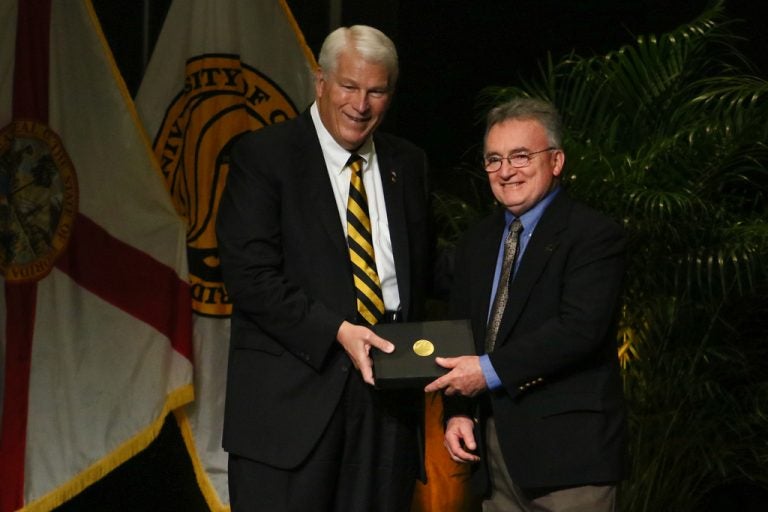 President John C. Hitt presents a 45-year service award to Michael Hynes. (Photo by Nick Russett)