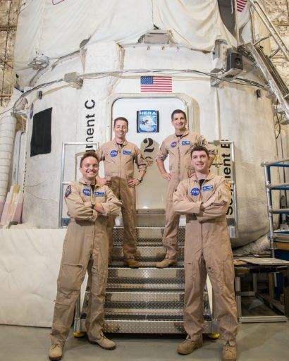 Courtesy of NASA: Crew members for the current simulation missions stand in front of the NASA Human Exploration Research Analog (HERA). HERA is a high-fidelity mission simulation environment operated by NASA’s Human Research Program (HRP) at the Johnson Space Center.
