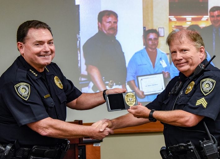 UCFPD Chief Richard Beary presents Sgt. Jerry Hartsfield with an honorary badge. Photo: Aileen Perilla