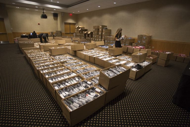 Workers prepare to hand out caps and gowns for 3,600 new graduates. Photo by Nick Russett/UCF