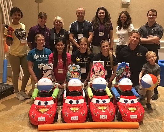 Jennifer Tucker, D.P.T., and Cole Galloway, Ph.D., (back row, third and fourth from left) with Patrick Pabian, D.P.T., (front row, far right) and other Go Baby Go! team members at the convention