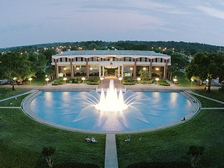 reflecting pond lit up at night in front of millican hall