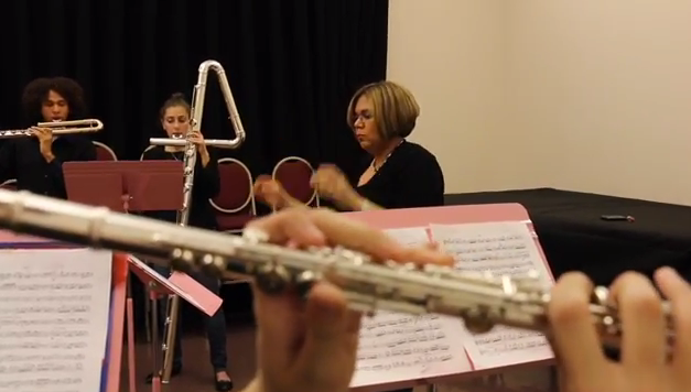 photo of students and teacher playing musical instruments