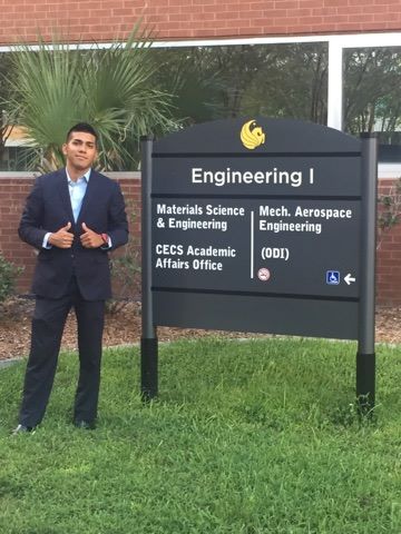 Alex Chavez, a junior majoring in mechanical engineering standing in front of the ucf engineering 1 building