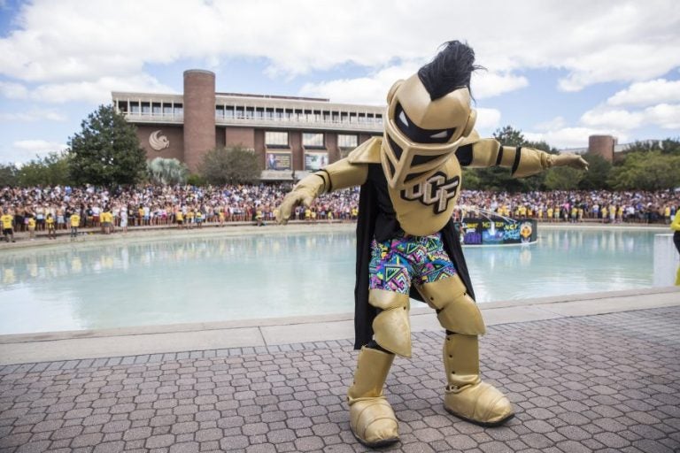 knightro amping up students for spirit splash in front of reflecting pond at ucf