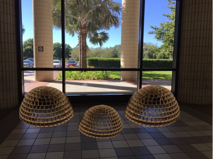 Three domes created by student Savannah Kloess from disposable coffee cup sleeves will be on display in the Visual Arts Building.
