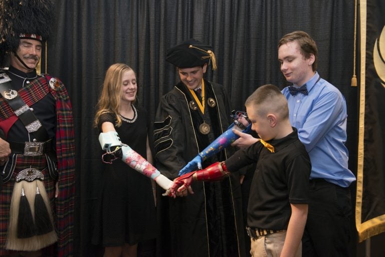 Bionic-arm recipients join Limbitless Solutions founder at UCF graduation