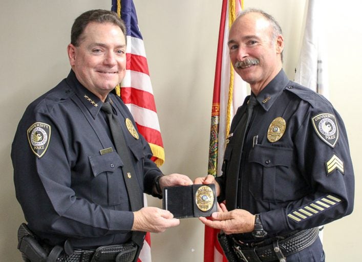 UCFPD Chief Richard Beary (left) presents Carpenter with his new lieutenant badge. Photos: Amanda Sellers