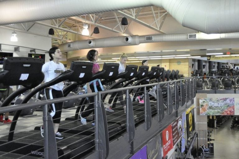 students on cardio machines in ucf rec and wellness center