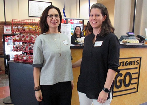 Nilly Waiserberg and Stephanie Libzon, with Diana Tafur inside the kiosk