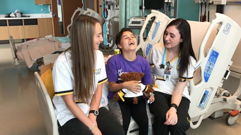 Karina Bermudez, 12, receives her Knight Nurse bear from UCF nursing students at Nemours Children's Hospital.