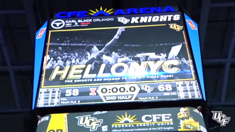 upward angle; photo at basketball game in nyc, megatron say "HELLO NYC" with ucf knights written on it