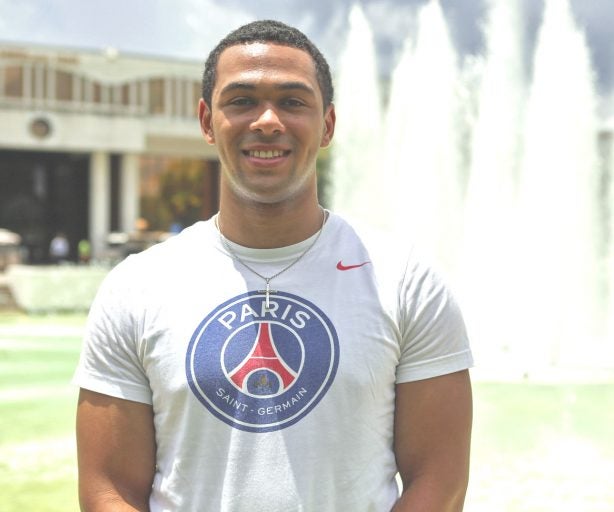 bryce nelson in front of reflecting pond fountain