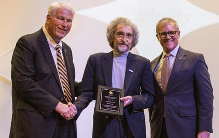 Chuck Dziuban (center) receives the Collective Excellence Award from President John C. Hitt and Provost Dale Whittaker.