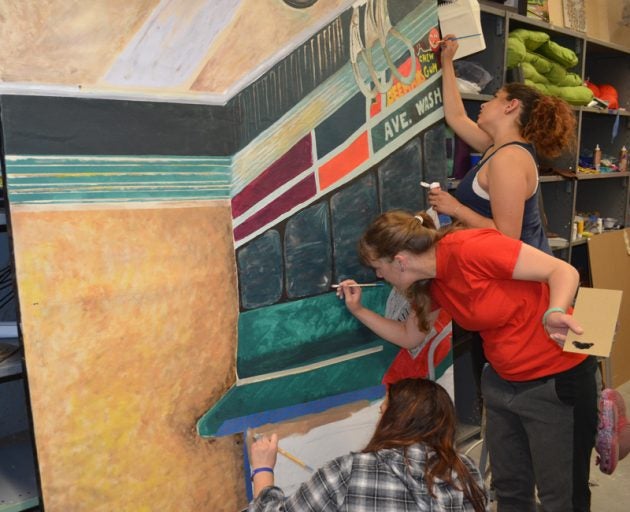 Art students add finishing touches to their tableau vivant, 'The Subway' by Palmer Hayden.