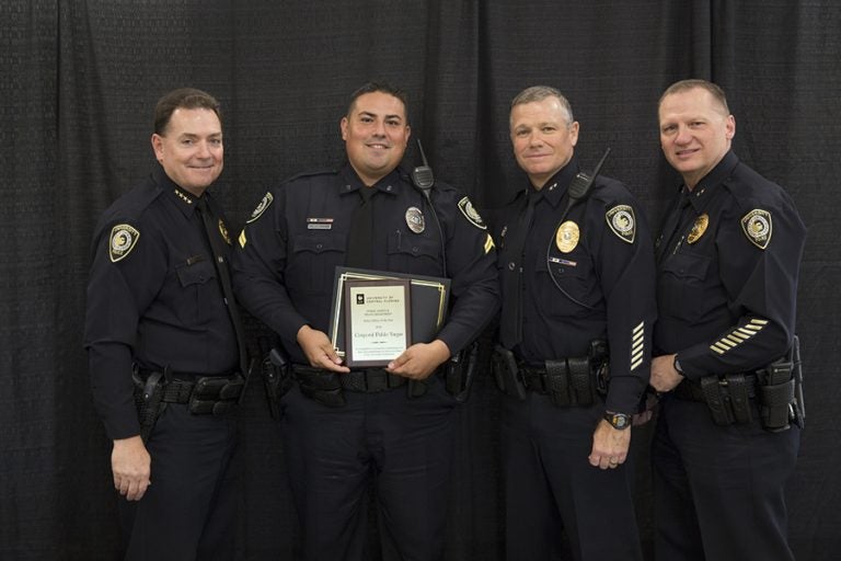 Chief Richard Beary and Deputy Chiefs Carl Metzger and Brett Meade congratulate Officer of the Year Corporal Pablo Vargas.