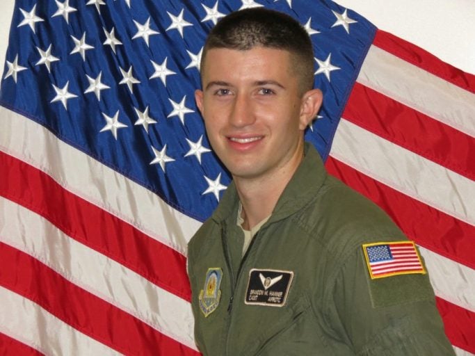 brandon hanner in military uniform in front of american flag background