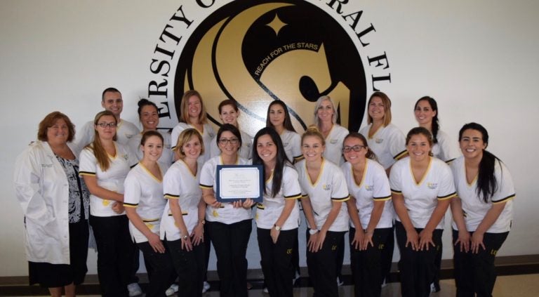 UCF Cocoa nursing students and their faculty mentor with one of their two national awards.