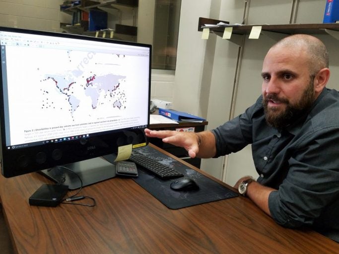 bearded man looking at computer screen