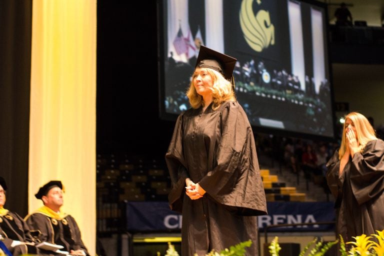 Cherie Carr walks the graduation stage on Aug. 5 with her sister, Vicki, just steps behind. Photo: Amanda Sellers