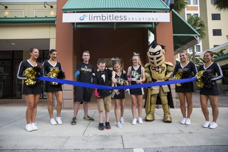 Bionic arm recipients Wyatt Falardeau, Alex Pring, Julianna Linton, and Annika “Anni” Emmert help cut the ribbon on Limbitless Solution's new lab.