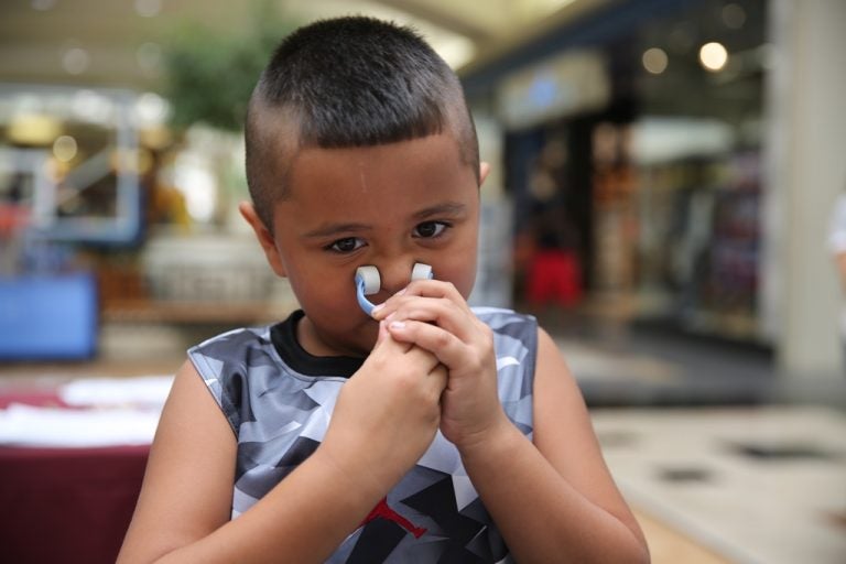 child taking free asthma screening test