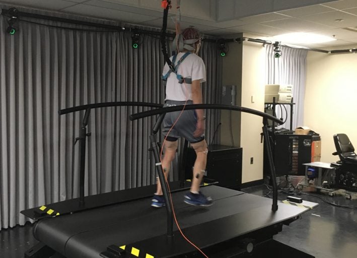 older male having an eeg performed while walking on treadmill