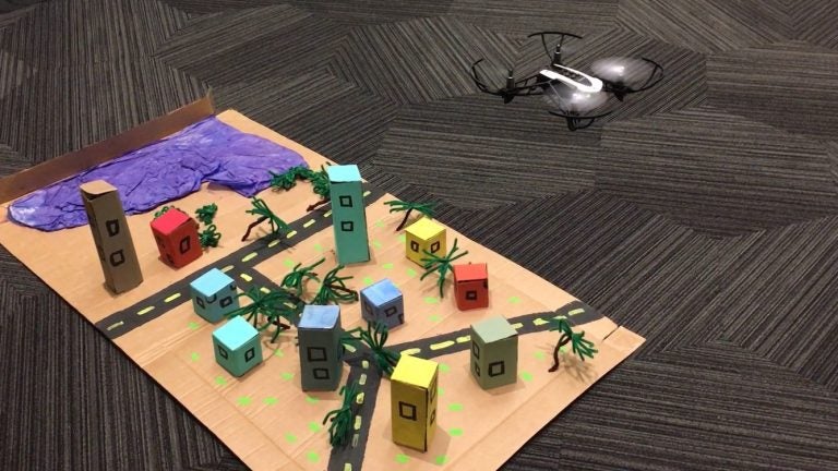 Students flew a mini drone over a model town to simulate how GIS professionals fly drones over land to capture images of pre-and-post natural disasters, shoreline changes over time, and more.