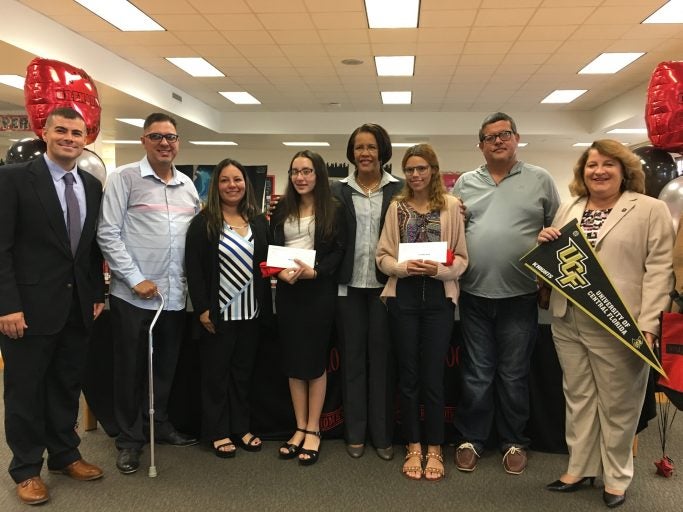 Yerianne Roldan and Zuleyka Avila, in the center with Orange County Public Schools Superintendent Barbara Jenkins, after being surprised with scholarships to Valencia College and UCF.