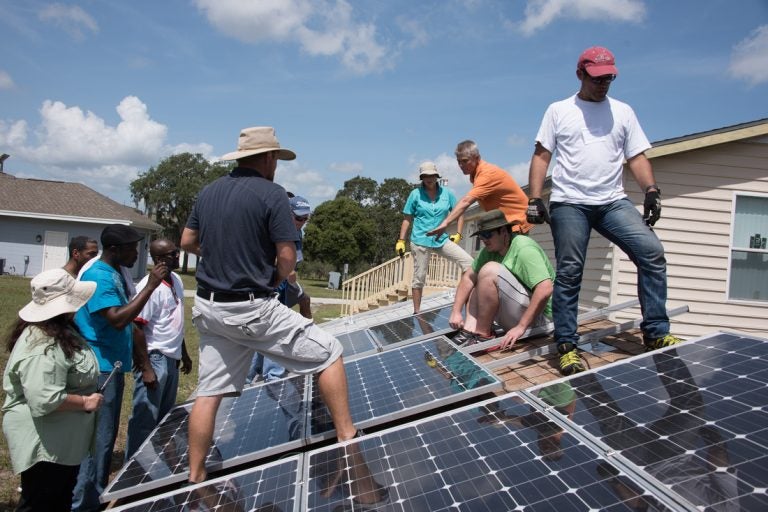 people working on solar panels