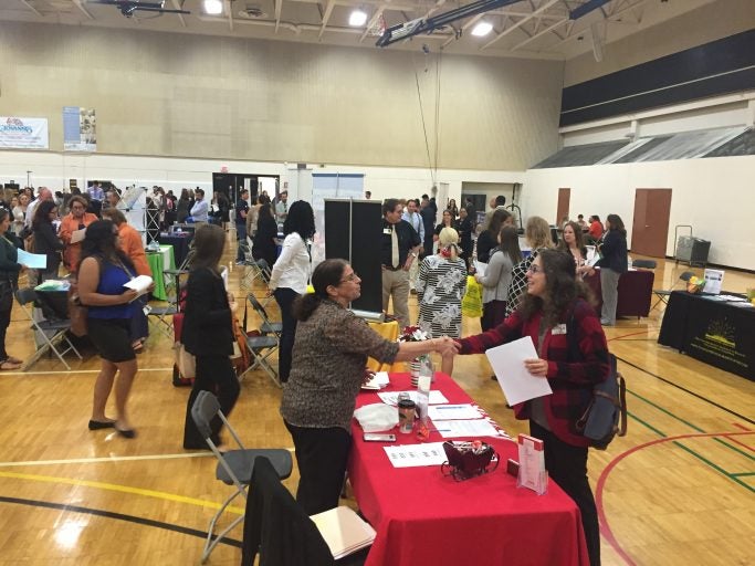 people shaking hands at career fair