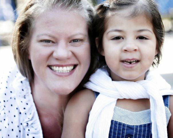 A woman smiles and poses for a photo with her eight-year-old daughter Marlie .