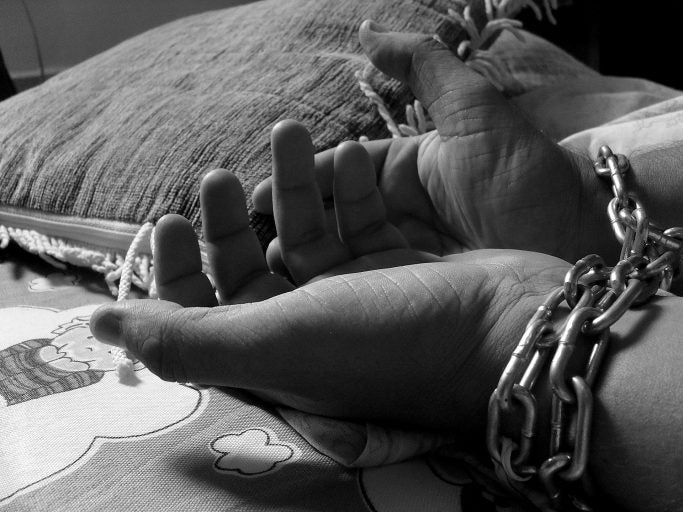 black and white photo on hands in handcuffs