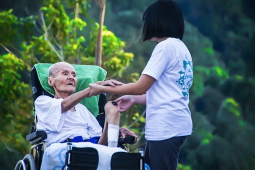 Caregiver taking care of an elderly patient