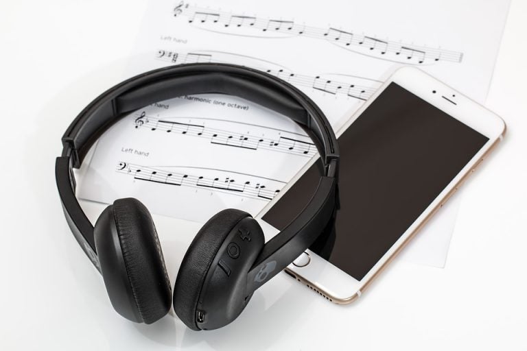 A pair of headphones and sheet music