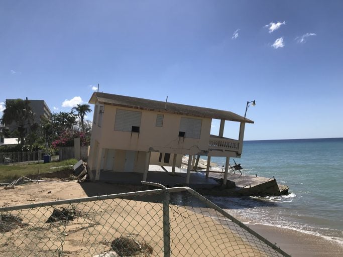 house on the edge of eroded beach