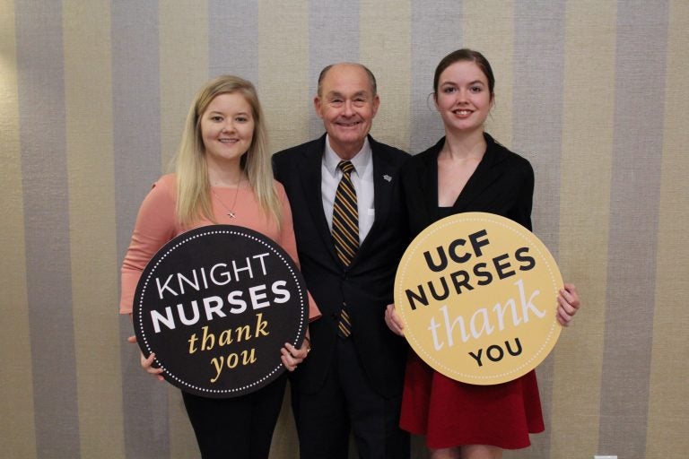 Scholarship recipients Rebecca Bruce (left) and Caitlin Cox, with duPont's John Lord.