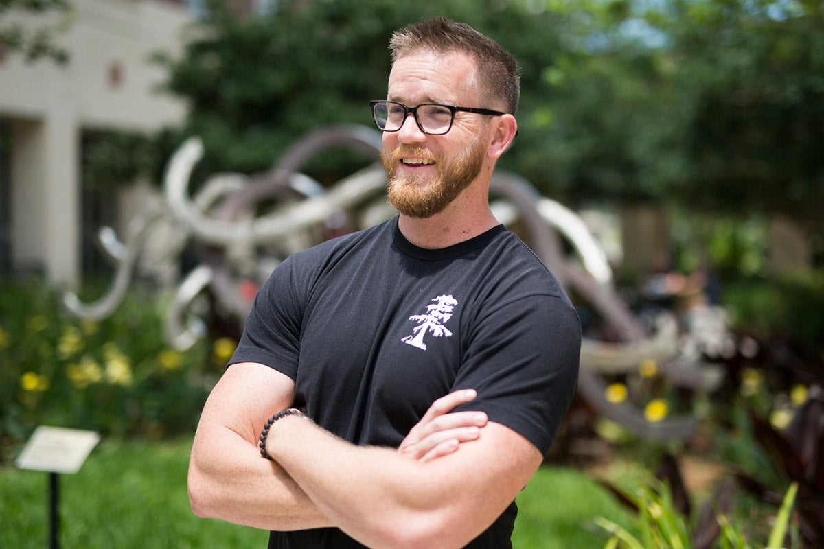 Evan “Brew Crew” Altes wears a “uniform” on campus to remind himself why he chose to finish his bachelor's degree at UCF. (Photo by Bernard Wilchusky)