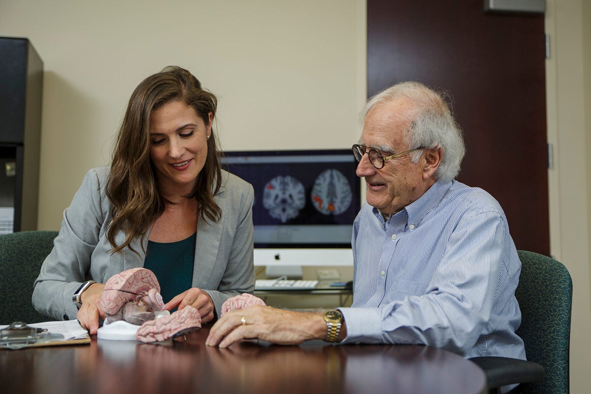 Assistant Professor of Psychology Nichole Lighthall works with a patient in the UCF Adult Development and Decision Lab. (Photo by Steven Diaz)