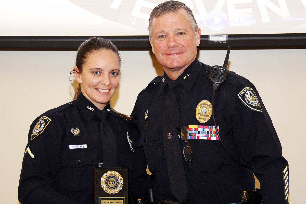 UCF Police Officer First Class Danielle Hughes ’13, pictured here with Deputy Chief Carl Metzger, was named Central Florida’s 2017 Crisis Intervention Team Office of the Year.