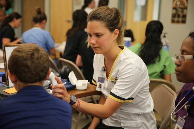 UCF nursing students working in teams with medical students at the Apopka Farmworker's Clinic.