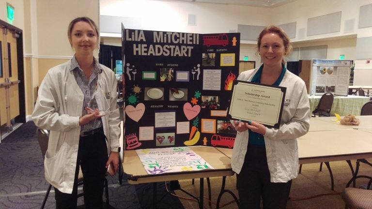 scholarship winners with poster