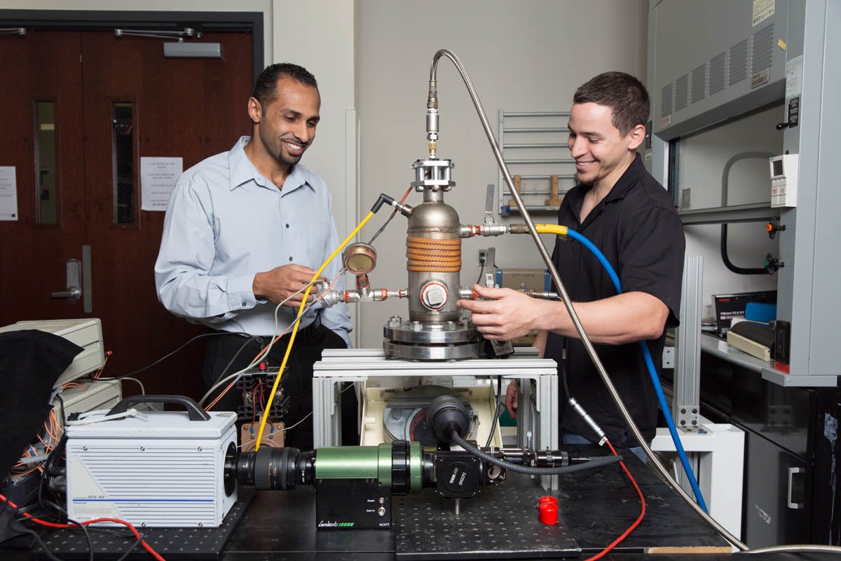 Assistant professor of engineering Kareem Ahmed (left) works with a research student in a lab. (Photo by Bernard Wilchusky)